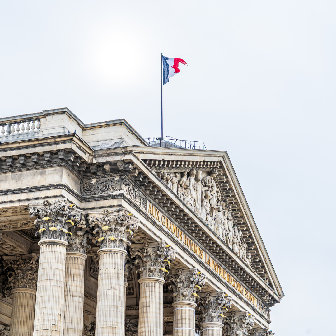 Outside a parliament building with a flag